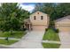Attractive two-story home with well-maintained landscaping and a spacious driveway leading to the garage at 5128 Grassy Knoll Dr, Tavares, FL 32778