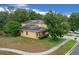 Charming two-story home featuring solar panels, a well-manicured lawn, and an inviting front porch with an American flag at 5128 Grassy Knoll Dr, Tavares, FL 32778