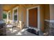 Charming front porch featuring a cozy bench and a welcoming entryway at 5128 Grassy Knoll Dr, Tavares, FL 32778