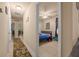 Hallway leading to a bedroom and another room, featuring tile flooring and neutral colored walls at 5128 Grassy Knoll Dr, Tavares, FL 32778
