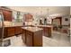 Spacious kitchen with granite countertops, center island, and ample cabinet space at 5128 Grassy Knoll Dr, Tavares, FL 32778