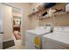 Well-equipped laundry room with modern washer and dryer, and storage shelving at 5128 Grassy Knoll Dr, Tavares, FL 32778