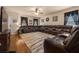 Inviting living room with a plush sectional sofa and wood floors, perfect for relaxation at 5128 Grassy Knoll Dr, Tavares, FL 32778