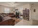 Comfortable living room with tile floors, ceiling fan, and sectional sofa at 5128 Grassy Knoll Dr, Tavares, FL 32778