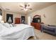 Spacious main bedroom with tile flooring, ceiling fan, walk-in closet, and an assortment of furniture at 5128 Grassy Knoll Dr, Tavares, FL 32778