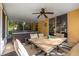 Back patio features a ceiling fan, dining table and chairs, and jacuzzi at 5128 Grassy Knoll Dr, Tavares, FL 32778