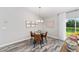 Dining area features modern furniture, stylish light fixture, and a sliding glass door to the backyard at 5976 Sw 129Th Place Rd, Ocala, FL 34473