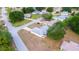 An aerial view showcases a neighborhood home with mature trees, landscaping and a long driveway at 6150 Sw 103Rd Loop, Ocala, FL 34476