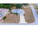 Aerial view of a well-maintained home with a two-car garage and large driveway in a serene neighborhood at 6150 Sw 103Rd Loop, Ocala, FL 34476