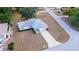 An aerial view of a single-Gathering home with a long driveway and a well-manicured front lawn at 6150 Sw 103Rd Loop, Ocala, FL 34476