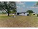 Lush backyard showcases ample space, with a partially screened-in patio and a charming, well-kept lawn at 6150 Sw 103Rd Loop, Ocala, FL 34476