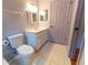 Bathroom features a toilet, white vanity, and decorative mirror at 6150 Sw 103Rd Loop, Ocala, FL 34476