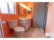 Well-lit bathroom with toilet, sink, vanity and white cabinets at 6150 Sw 103Rd Loop, Ocala, FL 34476