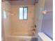 Bathroom features a shower and tub combination with a window at 6150 Sw 103Rd Loop, Ocala, FL 34476