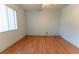 Bright bedroom with hardwood floors, a ceiling fan, and a window with vertical blinds at 6150 Sw 103Rd Loop, Ocala, FL 34476