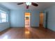 This spacious bedroom features wood flooring, a ceiling fan, and an ensuite bathroom at 6150 Sw 103Rd Loop, Ocala, FL 34476