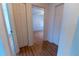 Bedroom featuring wood-look floors and an open door, creating a warm, inviting space at 6150 Sw 103Rd Loop, Ocala, FL 34476