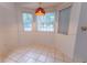 Bright breakfast nook with light tile flooring and three windows allowing for ample natural light at 6150 Sw 103Rd Loop, Ocala, FL 34476