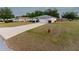 A quaint single-story home with a long driveway and lush green lawn in a quiet neighborhood at 6150 Sw 103Rd Loop, Ocala, FL 34476