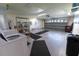 Spacious garage with laundry, storage shelving, and an automatic garage door at 6150 Sw 103Rd Loop, Ocala, FL 34476