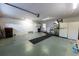 Well-lit garage area including a washer and dryer, refrigerator, and storage shelving at 6150 Sw 103Rd Loop, Ocala, FL 34476