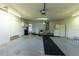 A clean, organized garage with a washer and dryer, refrigerator, and access to the house at 6150 Sw 103Rd Loop, Ocala, FL 34476