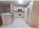 Bright kitchen featuring white cabinetry, stainless steel appliances, and tile flooring at 6150 Sw 103Rd Loop, Ocala, FL 34476