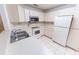 Bright kitchen features tile flooring, white cabinets, and stainless steel appliances at 6150 Sw 103Rd Loop, Ocala, FL 34476