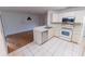 Eat-in kitchen boasts stainless steel appliances, white cabinetry, and tile flooring at 6150 Sw 103Rd Loop, Ocala, FL 34476