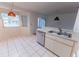 Kitchen with a view of breakfast nook; boasting white cabinets and tile flooring at 6150 Sw 103Rd Loop, Ocala, FL 34476