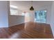 Living area with hardwood floors leading to the kitchen and a bright sunroom at 6150 Sw 103Rd Loop, Ocala, FL 34476