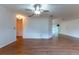 Open-concept living room with ceiling fan and a view to the screened lanai at 6150 Sw 103Rd Loop, Ocala, FL 34476