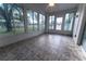 Sunroom with tile flooring, large windows, and natural light, offering a view of the outdoors at 6150 Sw 103Rd Loop, Ocala, FL 34476