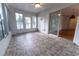 A sunroom provides lots of natural light, tile flooring, and easy access to the outside at 6150 Sw 103Rd Loop, Ocala, FL 34476