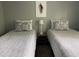 Bedroom featuring two twin beds with patterned bedding, and modern decor at 6432 Nw 64Th Ter, Ocala, FL 34482