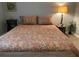 Bedroom with floral bedding and decor, creating a serene and inviting retreat at 6432 Nw 64Th Ter, Ocala, FL 34482