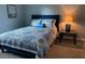 Bedroom with patterned bedding, providing a relaxing and stylish retreat at 6432 Nw 64Th Ter, Ocala, FL 34482