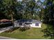 Charming single-story home with a well-manicured lawn and mature trees surrounding the property at 6432 Nw 64Th Ter, Ocala, FL 34482