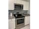 Modern kitchen with stainless steel appliances and white cabinetry at 6432 Nw 64Th Ter, Ocala, FL 34482