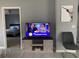 Bright living room showcases a weathered wood cabinet with a flat screen TV and gray accent walls at 6432 Nw 64Th Ter, Ocala, FL 34482
