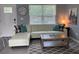 Bright living room features a white leather sofa, stylish rug, and decor at 6432 Nw 64Th Ter, Ocala, FL 34482