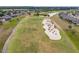 A high aerial shot of a well-manicured golf course winding through a residential community with a lake at 6816 Sw 95Th Cir, Ocala, FL 34481