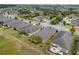 Bird's-eye view of houses with landscaped yards in a community near a golf course at 6816 Sw 95Th Cir, Ocala, FL 34481