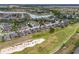 Aerial view featuring a residential community on a golf course with a lake and lush landscaping at 6816 Sw 95Th Cir, Ocala, FL 34481