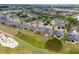 A high aerial of houses situated near a golf course and a winding lake at 6816 Sw 95Th Cir, Ocala, FL 34481
