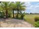 Paver patio featuring tropical landscaping and golf course views, perfect for outdoor relaxation and enjoying the scenery at 6816 Sw 95Th Cir, Ocala, FL 34481