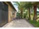 Outdoor living space featuring a paver patio, framed by tropical plants, ideal for enjoying the tranquil surroundings at 6816 Sw 95Th Cir, Ocala, FL 34481