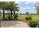 Paver patio overlooking the golf course, surrounded by lush tropical plants and landscaping for a serene outdoor experience at 6816 Sw 95Th Cir, Ocala, FL 34481