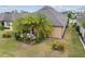 Lush backyard with tropical landscaping around a covered patio, creating a private outdoor oasis at 6816 Sw 95Th Cir, Ocala, FL 34481