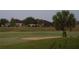 View of the manicured backyard and golf course behind the house at 6816 Sw 95Th Cir, Ocala, FL 34481